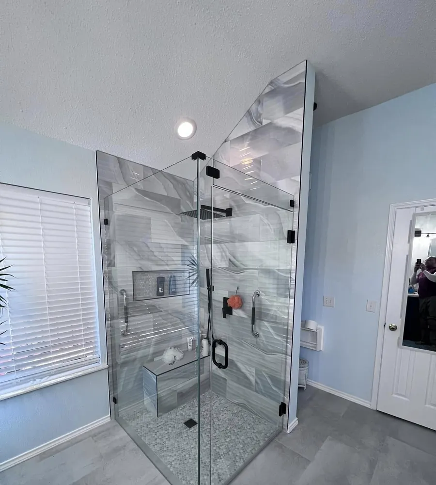 Frameless glass shower with a bench and niche