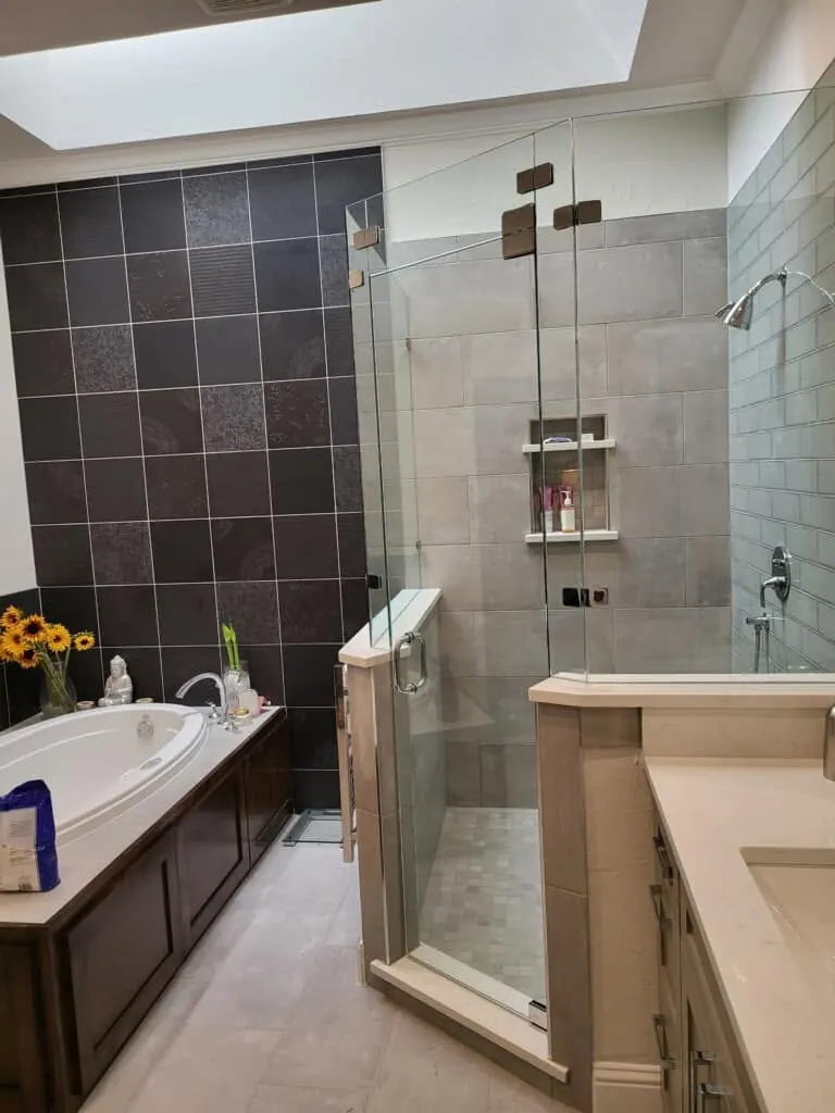 Glass corner shower beside a drop-in tub