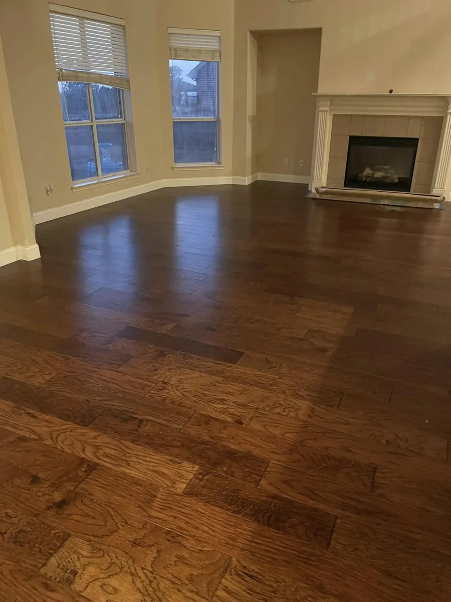 Plank flooring in a living room with a fireplace