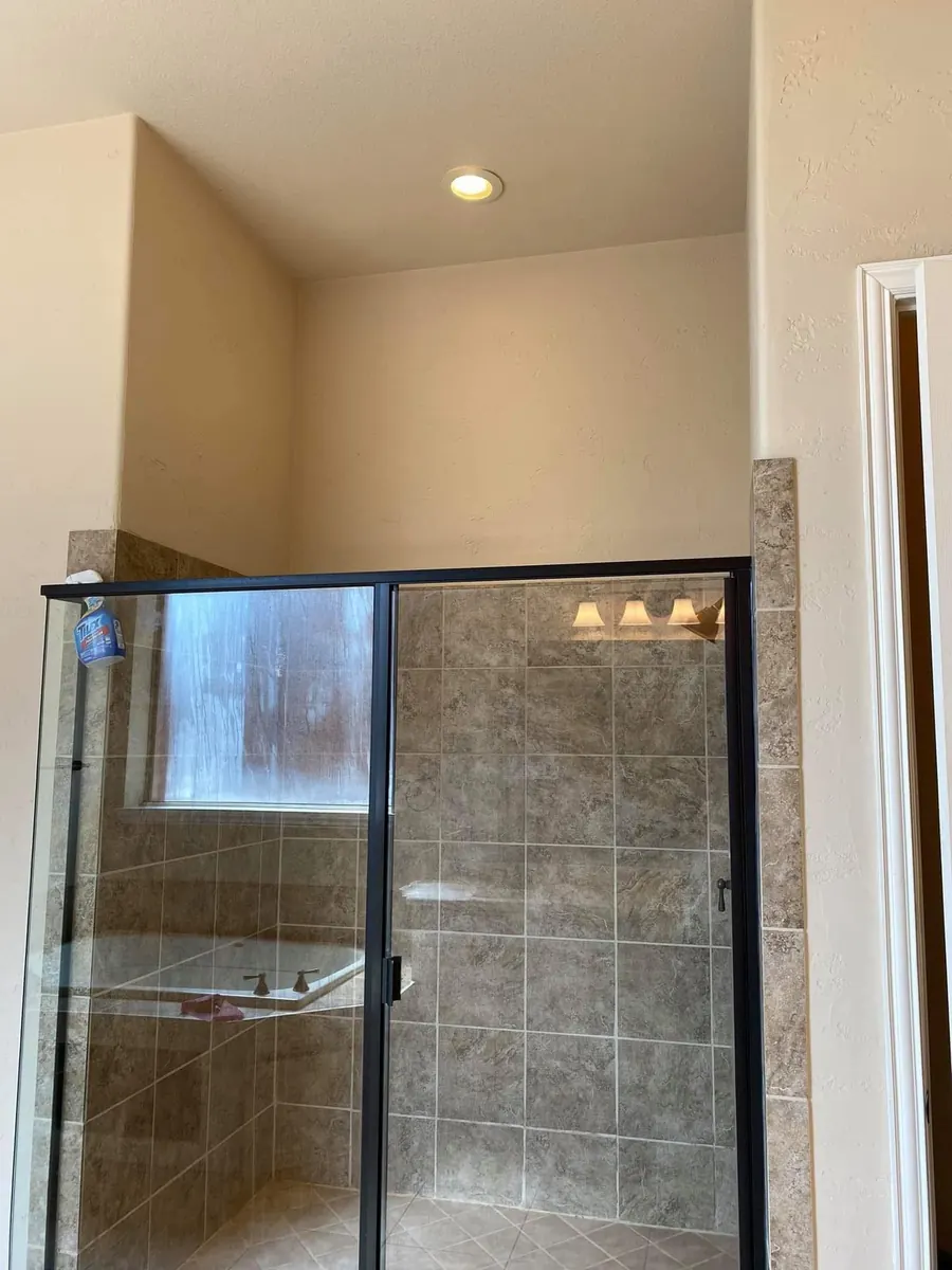 Before: Framed tile shower to a frameless glass walk-in with bench