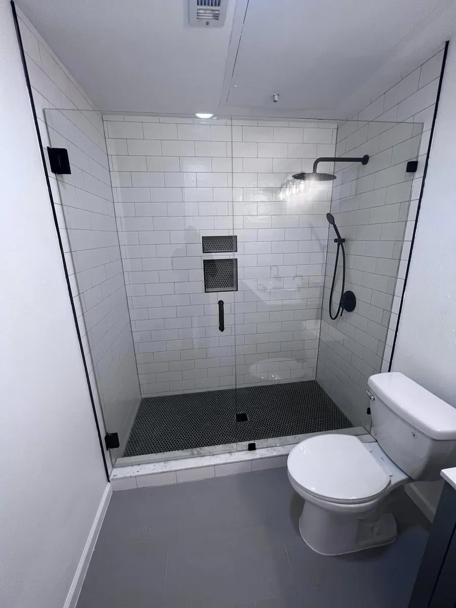 After: Down to the studs, rebuilt with subway tile and a built-in niche