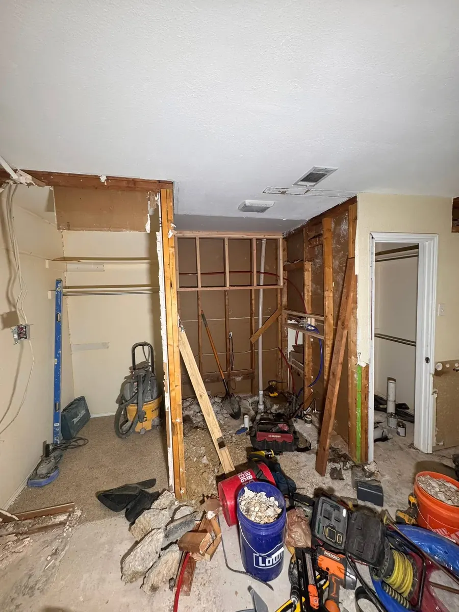 Before: Bathroom transformation featuring a custom walk-in shower with a full-width built-in niche